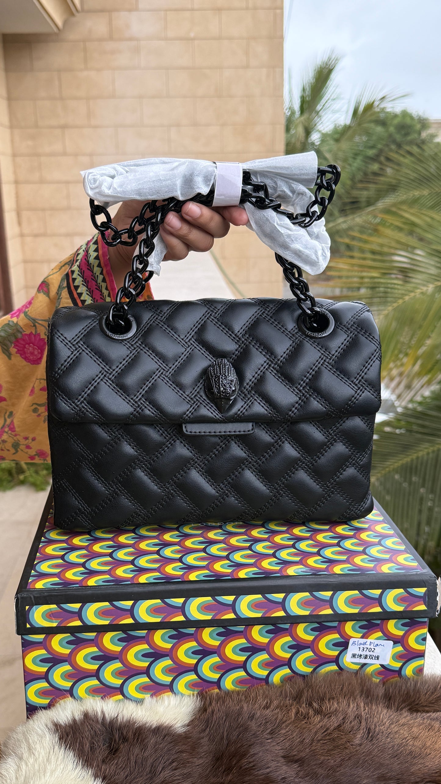 Kurt Geiger Kensington Drench Shoulder Bag, featuring a distinct all-black quilted leather design and a black eagle head charm.Master Series-Box included