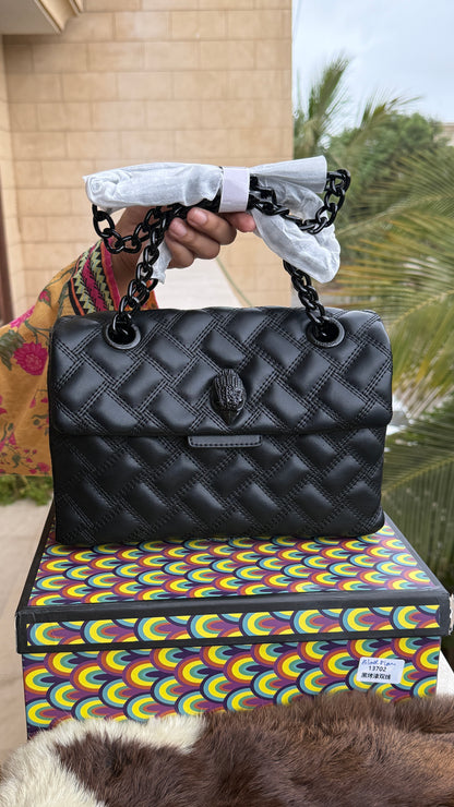 Kurt Geiger Kensington Drench Shoulder Bag, featuring a distinct all-black quilted leather design and a black eagle head charm.Master Series-Box included