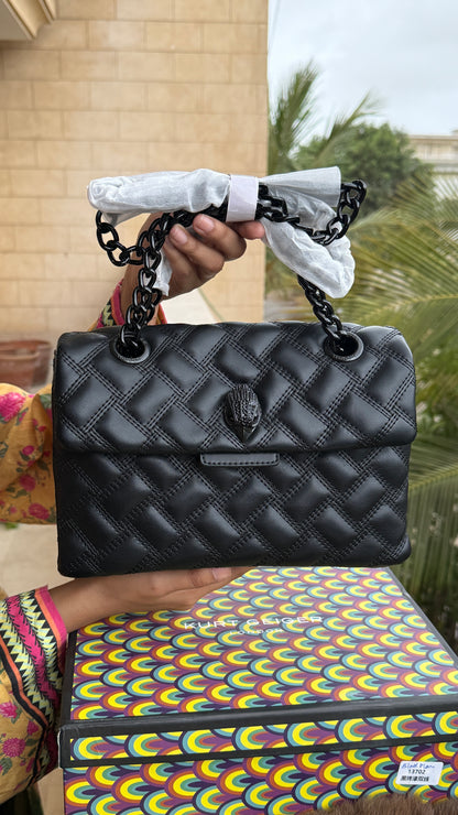 Kurt Geiger Kensington Drench Shoulder Bag, featuring a distinct all-black quilted leather design and a black eagle head charm.Master Series-Box included